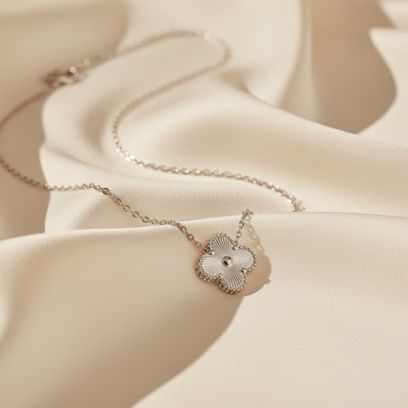 Delicate necklace with a heart-shaped pendant on a soft beige fabric background