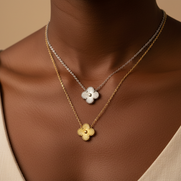 Two floral necklaces on a person against a beige background