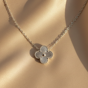 Necklace with a floral pendant on a beige fabric background