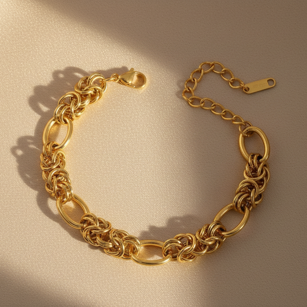 Gold chain bracelet on a beige background