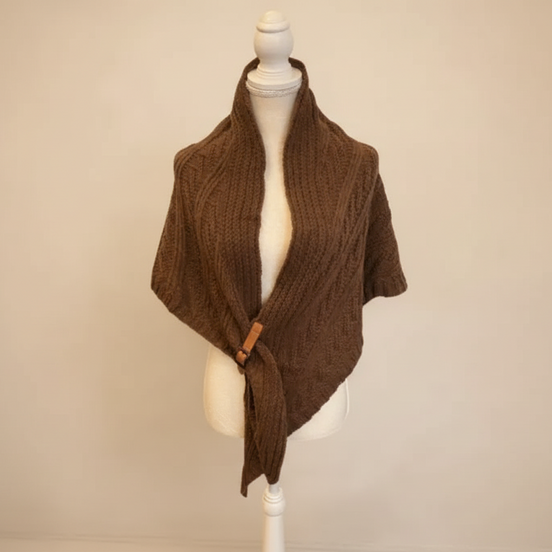 Brown knitted shrug on a mannequin against a beige background