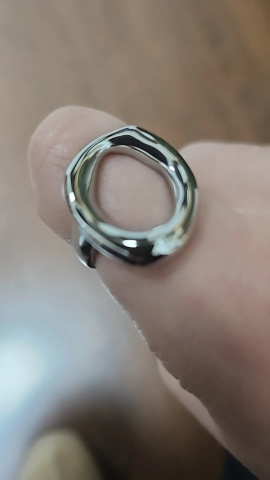 Close-up customer photo of the silver abstract oval ring