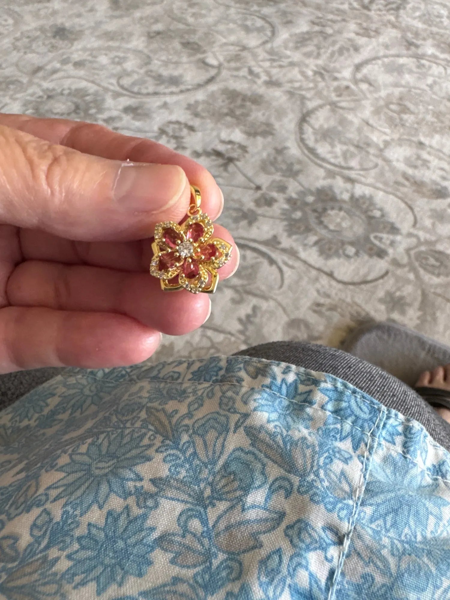 Customer holding the pink rotating flower pendant