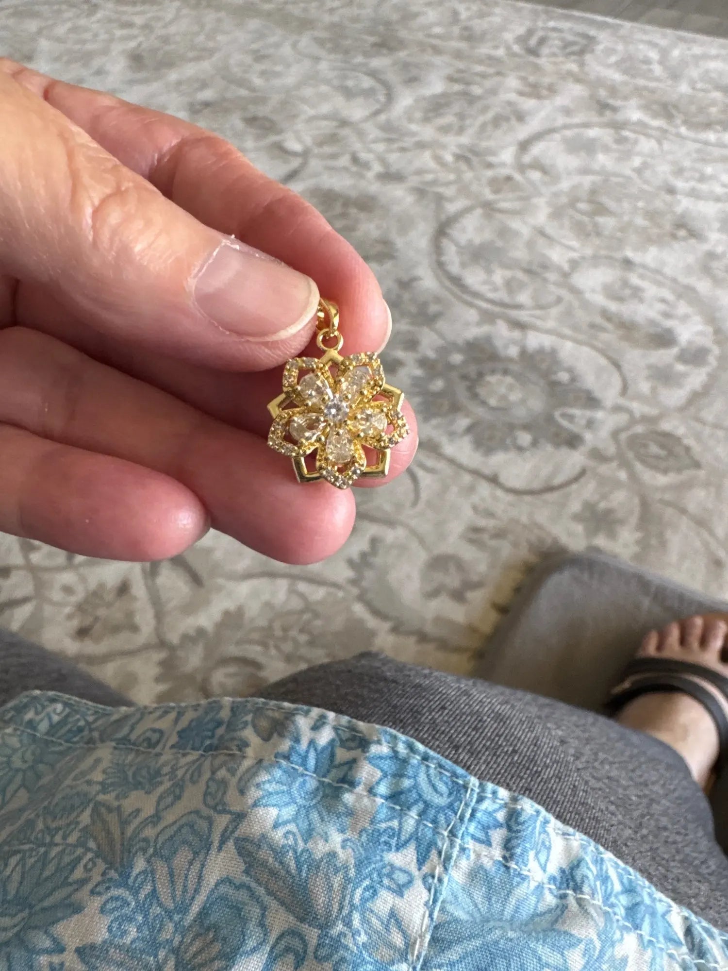 Customer holding the clear rotating flower pendant