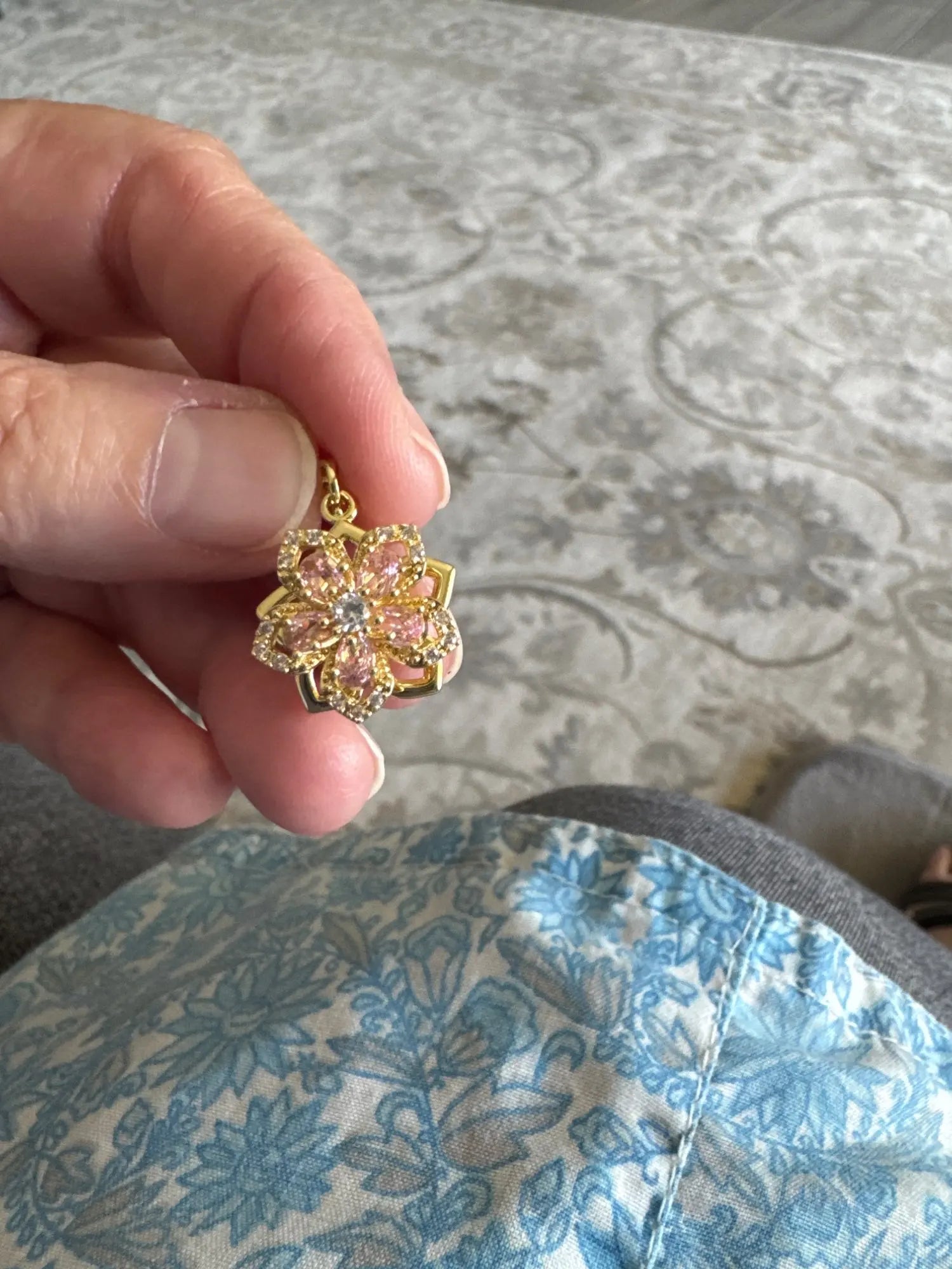 Customer holding the red rotating flower pendant