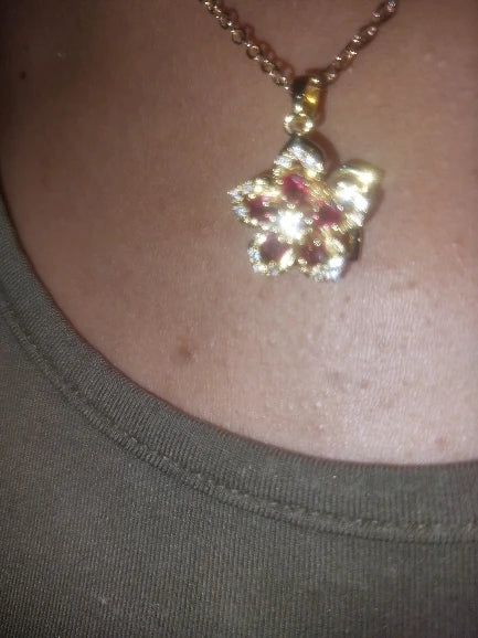 Clear rotating flower pendant worn by a customer