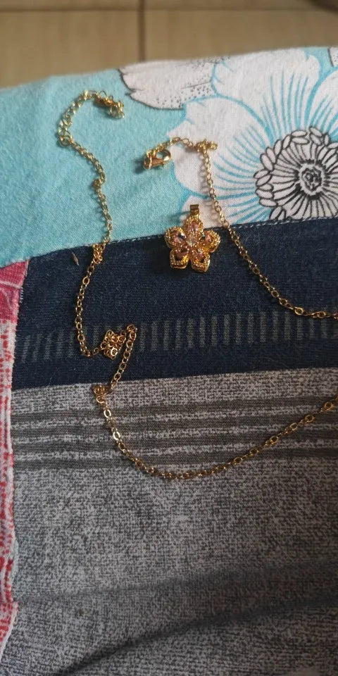 Pink rotating flower pendant worn by a customer
