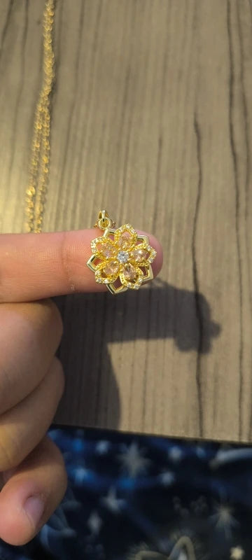Customer holding the pink rotating flower pendant